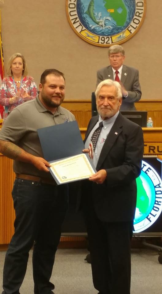 Tyler being recognized for being a combat wounded veteran by the Charlotte County Commissioner, Stephen R. Deutsch in 2017.
