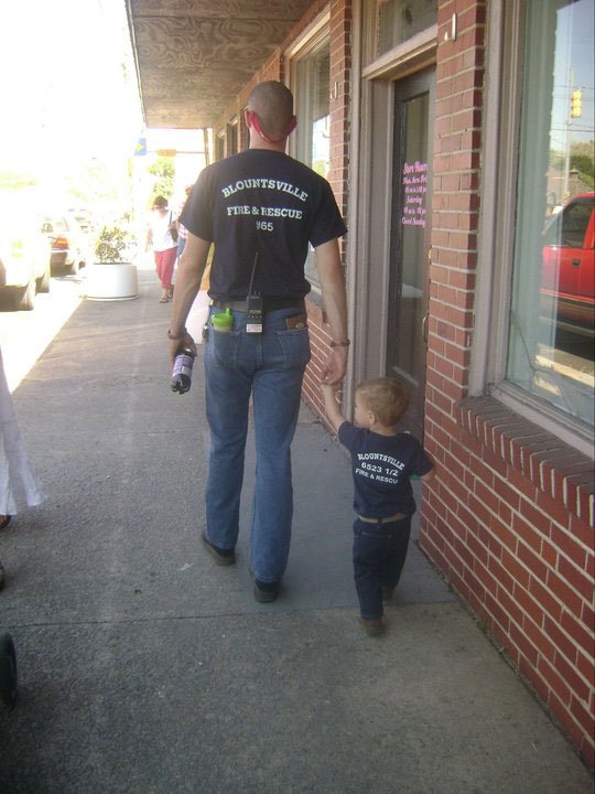 David teaching his son about the volunteer fire service.