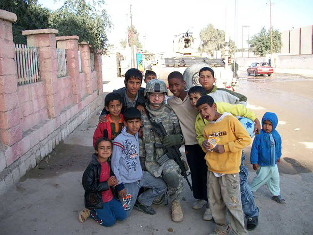 Taking pictures with the neighborhood kids after dropping off new school supplies for them. Al Shaibah, 2009