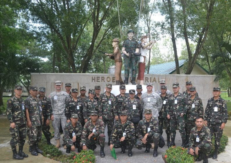 Mason Rick with his group of colleagues at Fort Ramon Magsaysay in the Philippines (in light green uniforms)