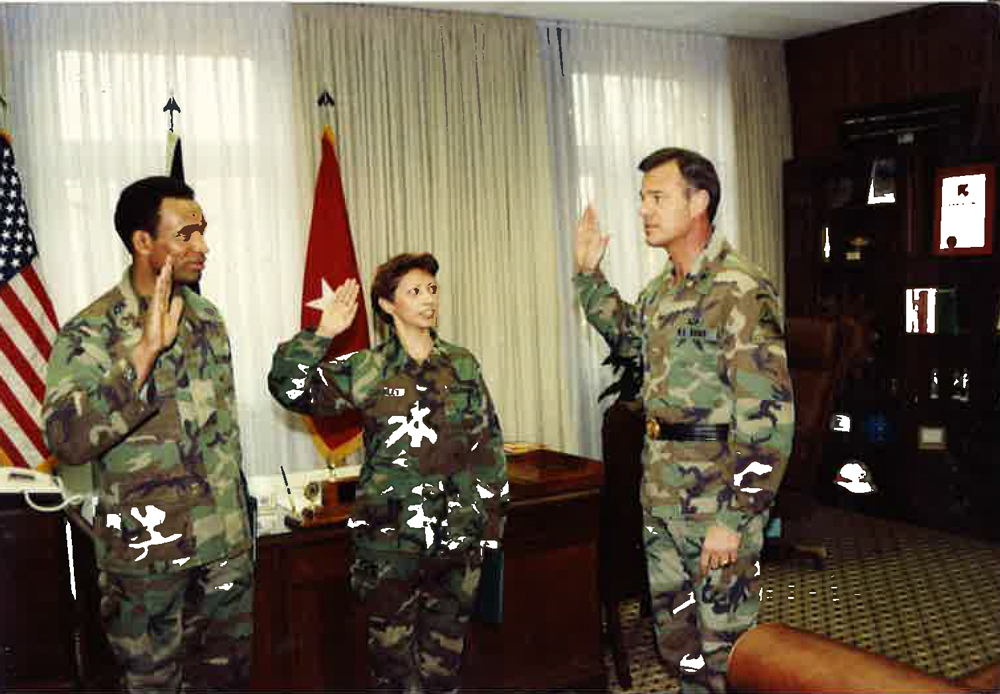 Brigadier General Brown reenlisting SFC. Carmen and SFC. Anthony Crawley. Neuburg, Germany, 1989