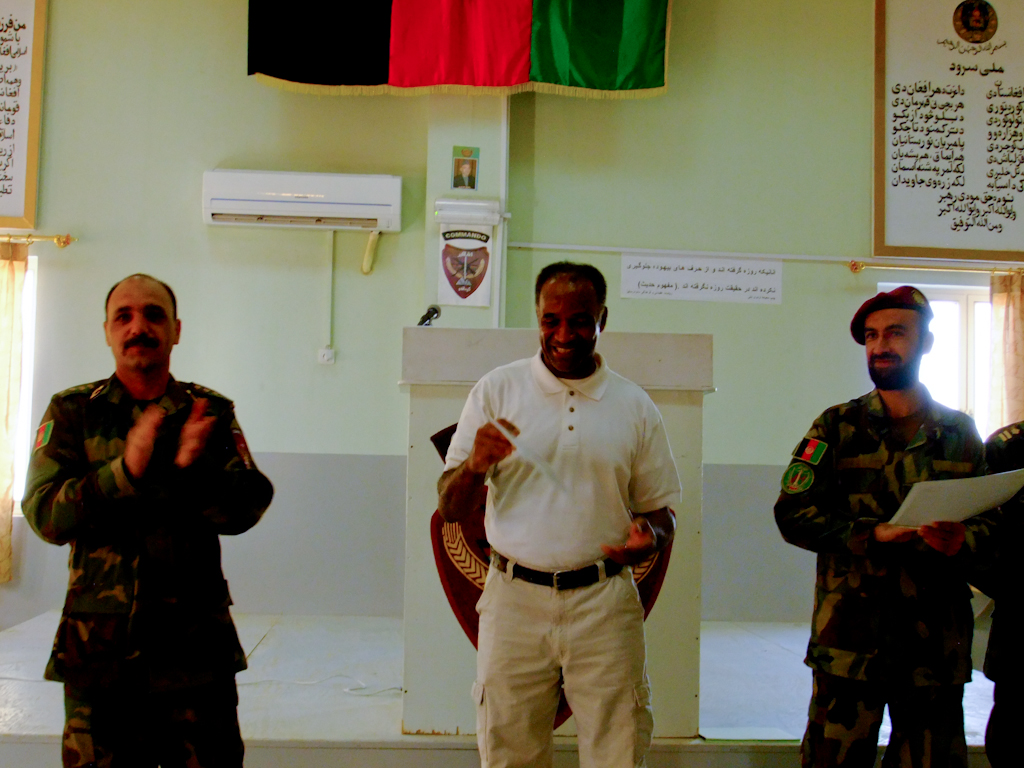 Commander, Staff and soldiers standing shoulder-to-shoulder wishing Anthony farwell, 2011