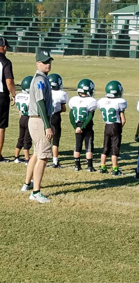 David coaching his boys' youth football team.