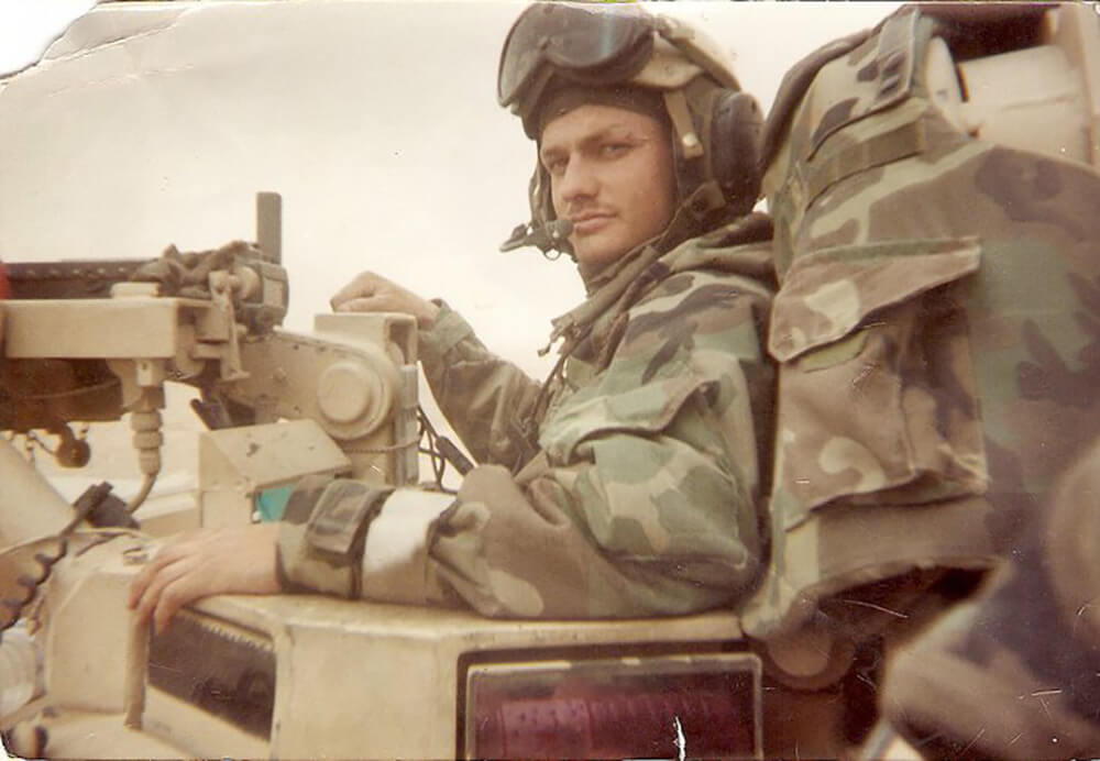 Picture of Keith in the tank commander’s hatch of his M1A1 Abrams tank as they crossed the southern desert