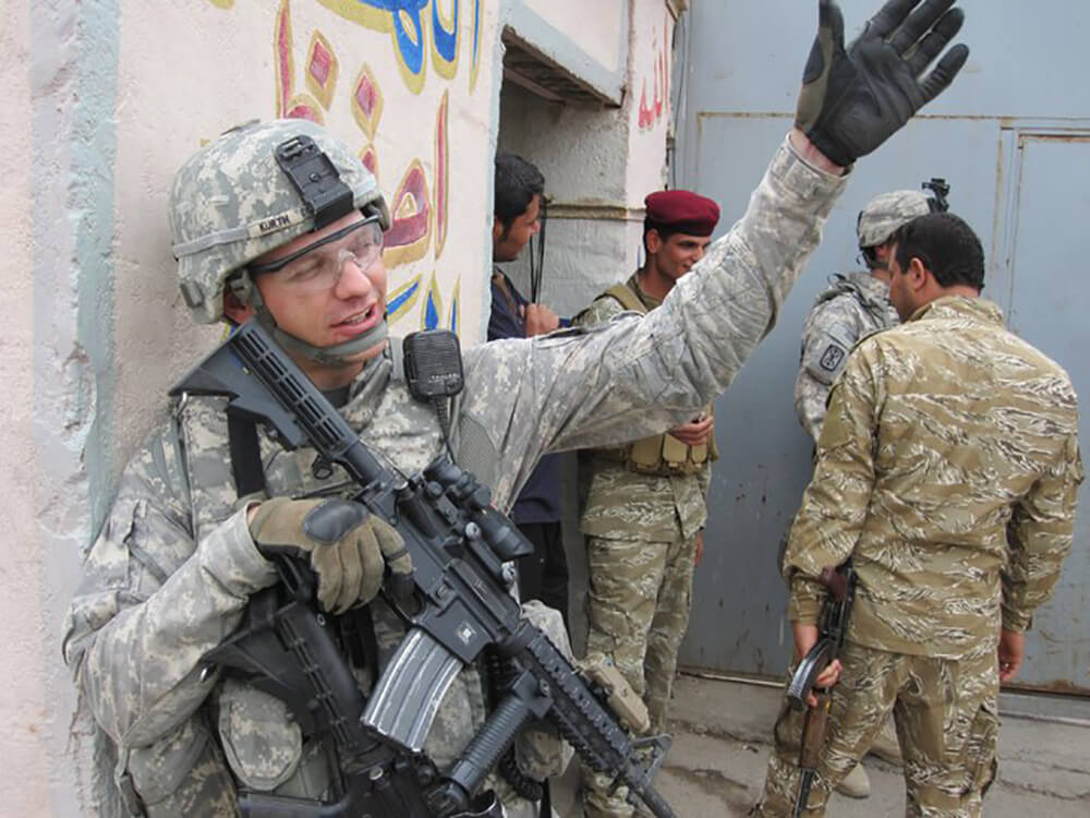 Keith in Basrah Iraq 2009 pulling security outside of the Iraqi Army Headquarters and talking to the Iraqi Soldiers