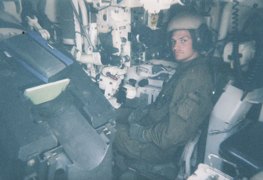 Keith in the gunners seat of his tank conducting rehearsals